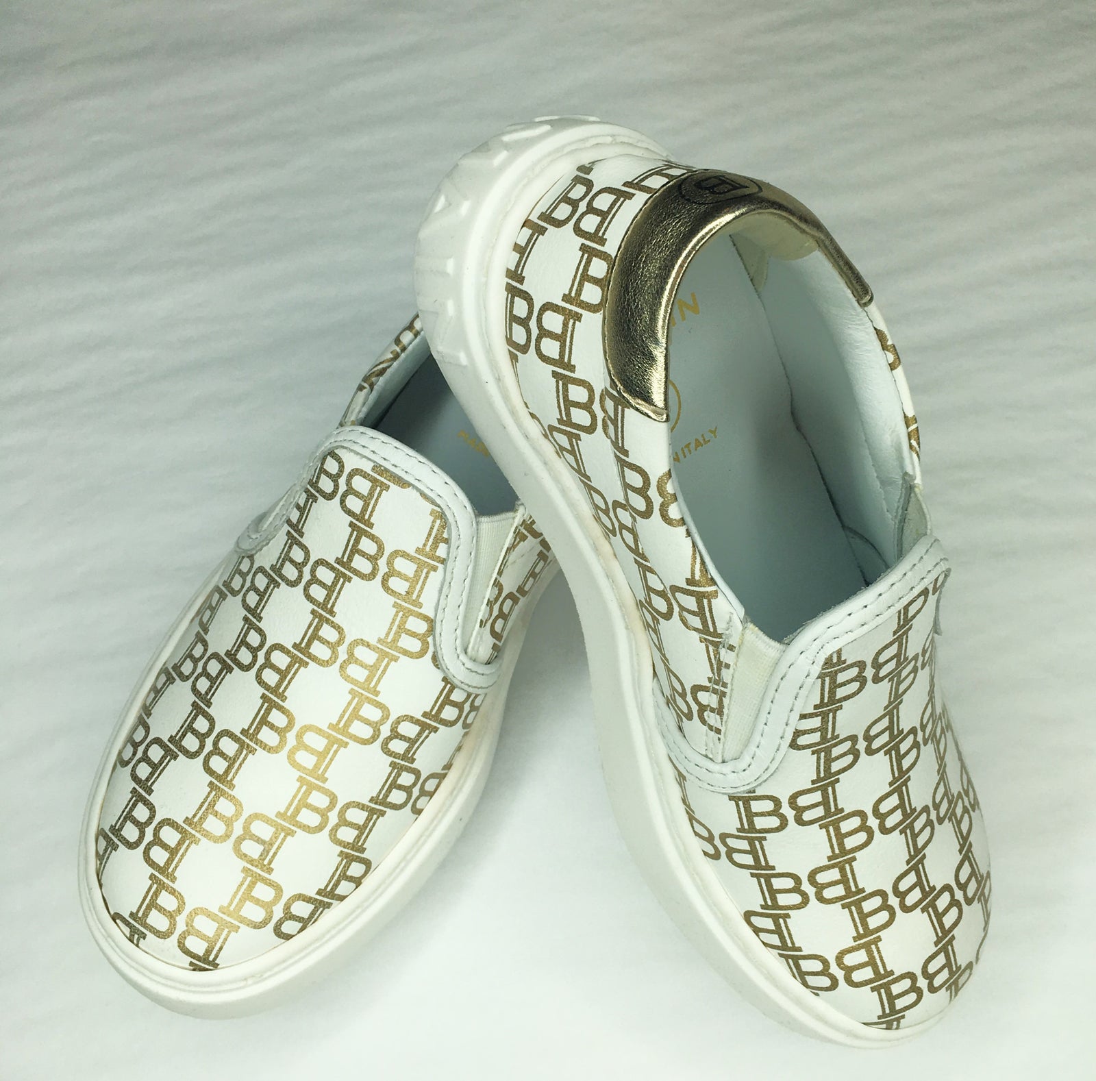 Balmain Kids Monogram All-Over Print Slip-On Trainers in white with gold – view 2 of 3