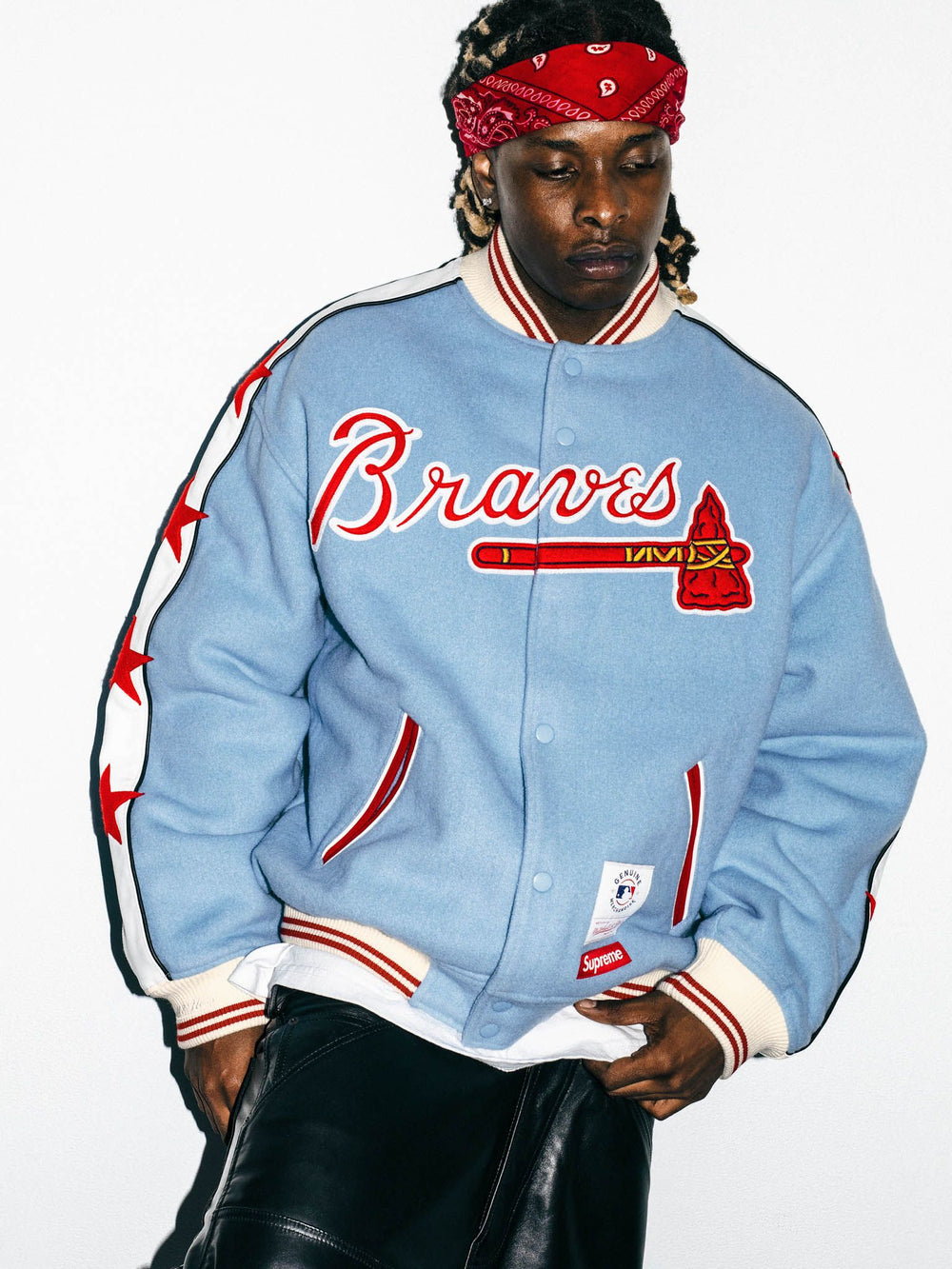 Supreme x Mitchell & Ness Atlanta Braves Wool Varsity Jacket in light blue, front on model