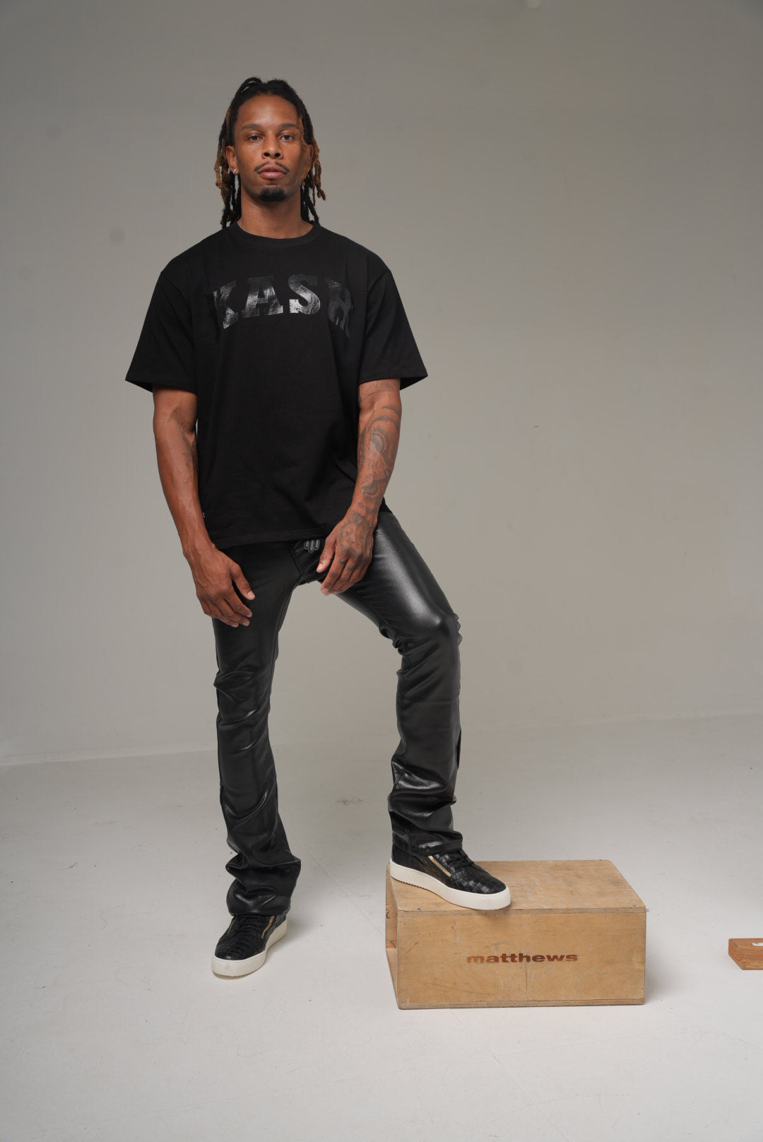 Kash vegan leather stacked pants in black on model