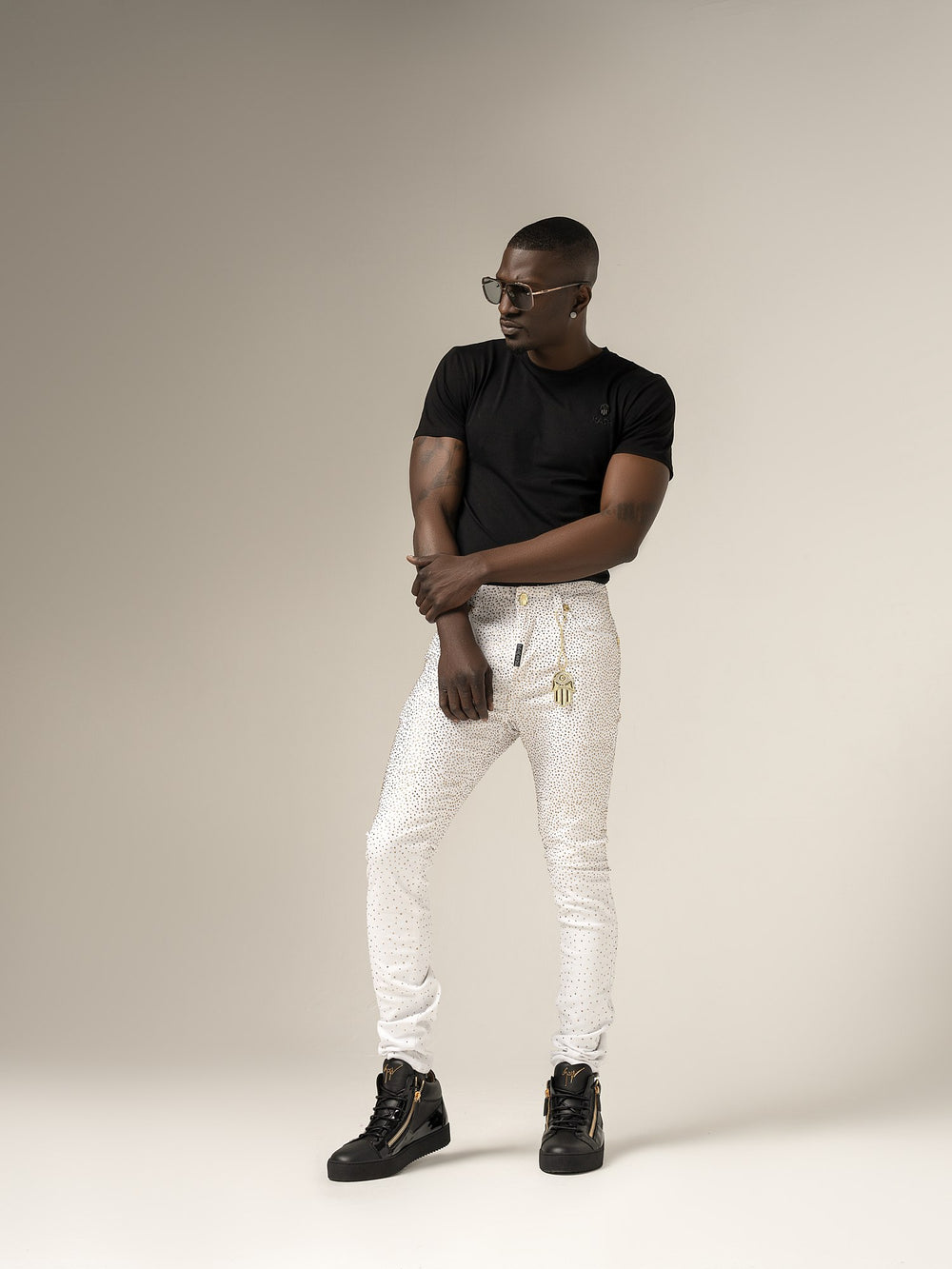 Kash Diamond Denim in white with gold crystals and gold Hamsa, on model