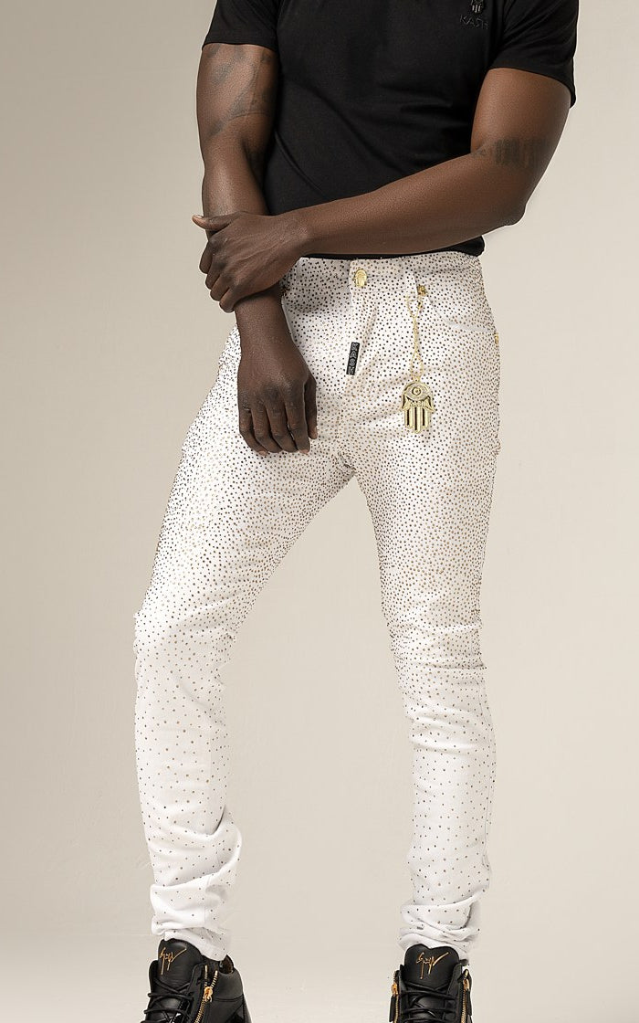 Close-up of Kash Diamond Denim in white with gold crystals and gold Hamsa fob