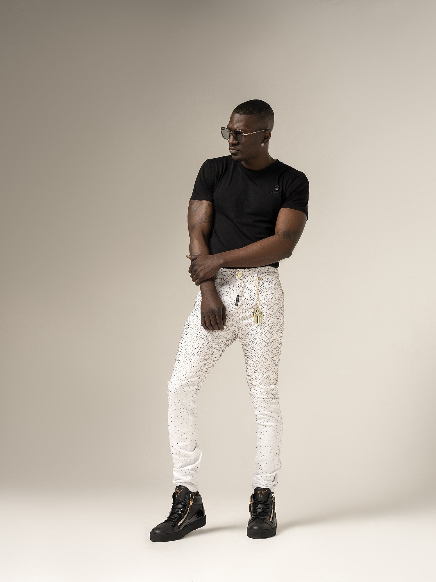 Kash Diamond Denim in white with gold crystals and gold Hamsa, on model